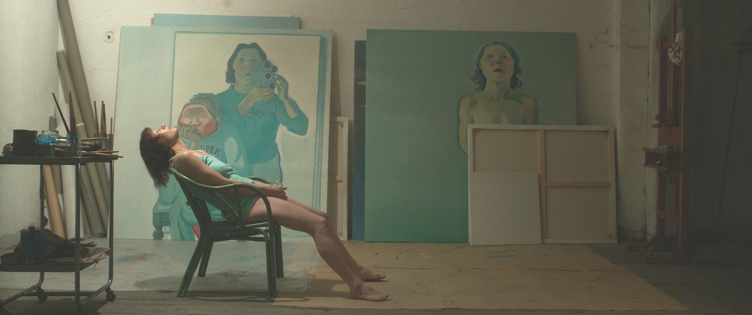 Maria Lassnig drawing on a large sheet of paper in Sleeping with a Tiger