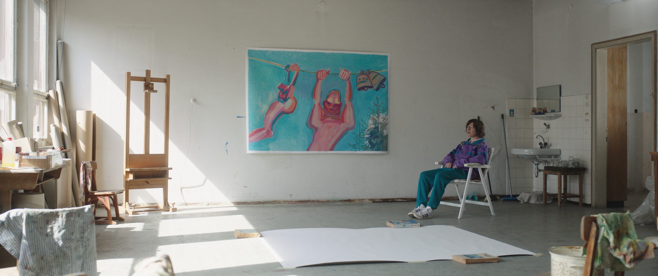 Maria Lassnig seated in a bright studio in Sleeping with a Tiger