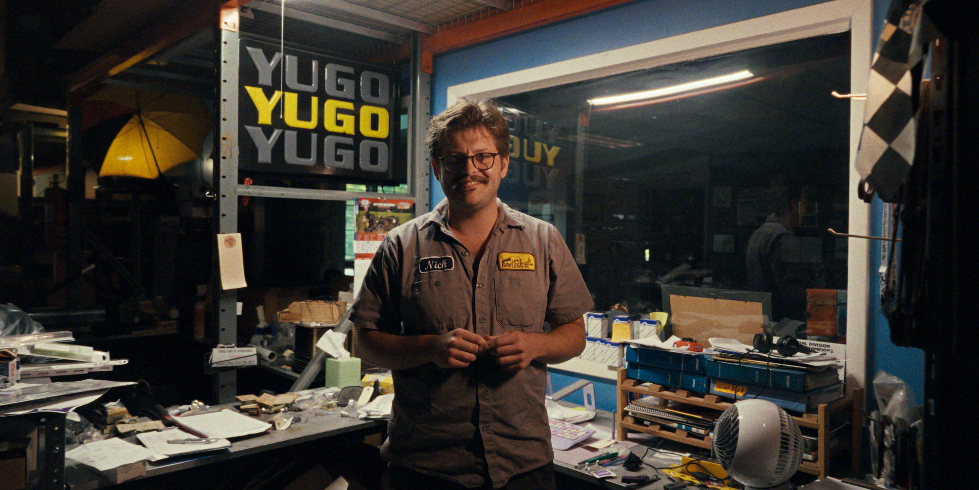 An interview with a participant in a garage full of automotive memorabilia