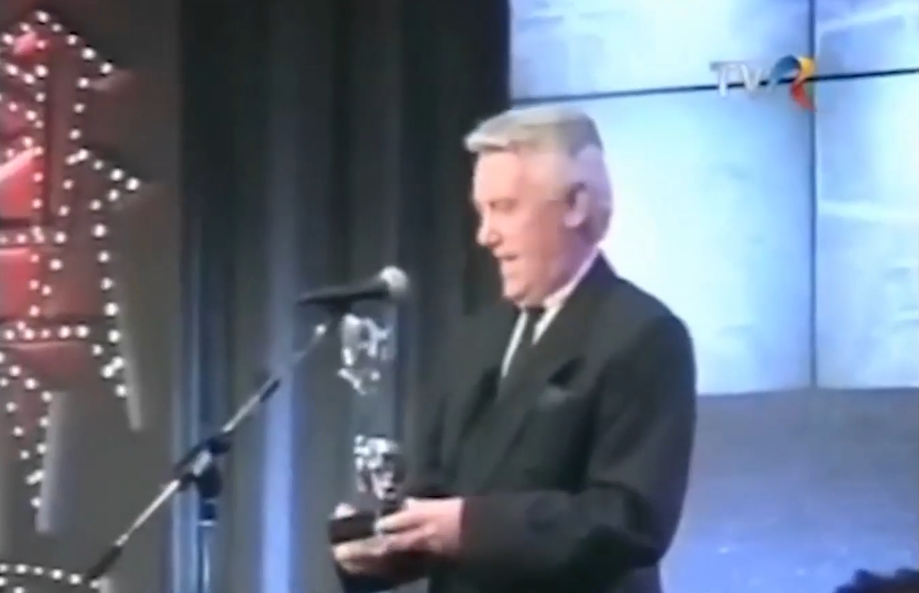 Television presenter in archival broadcast footage