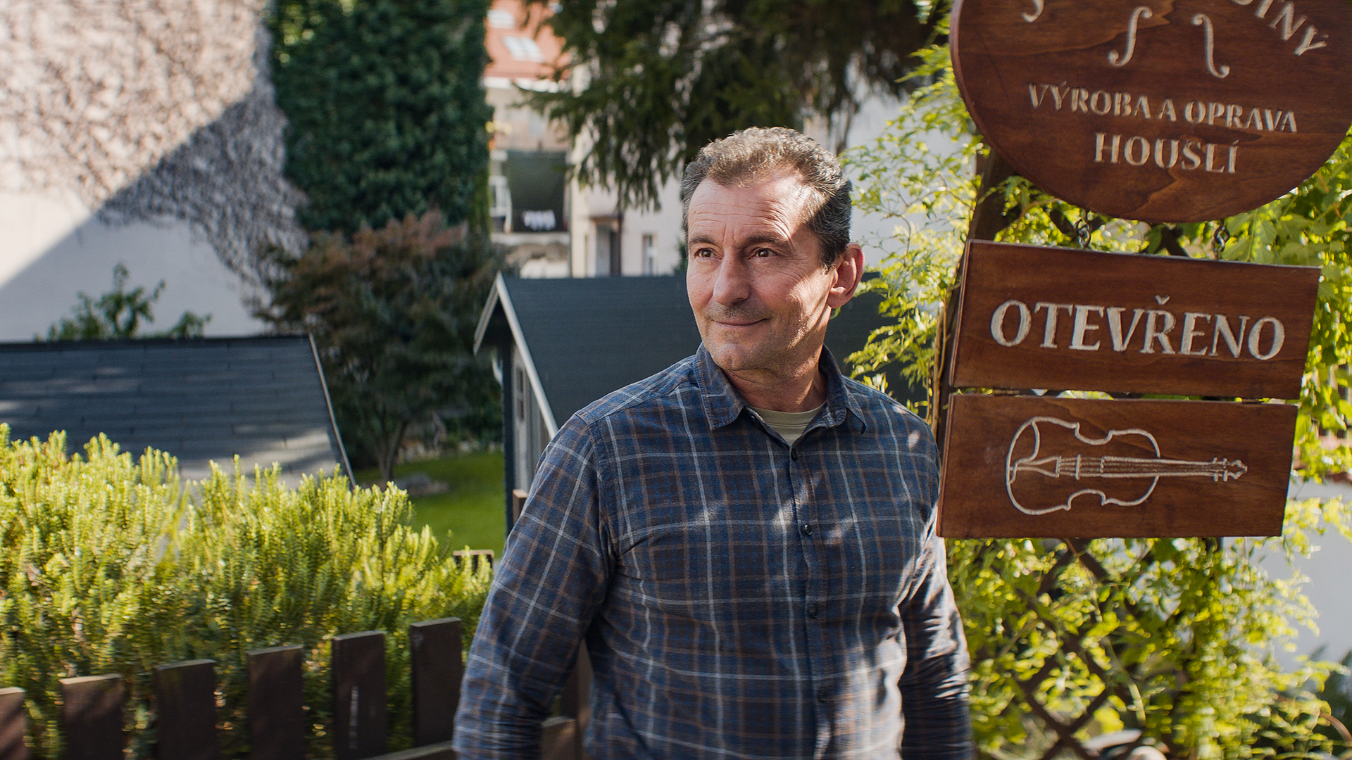 Josef outside his violin workshop in Sea of Hope